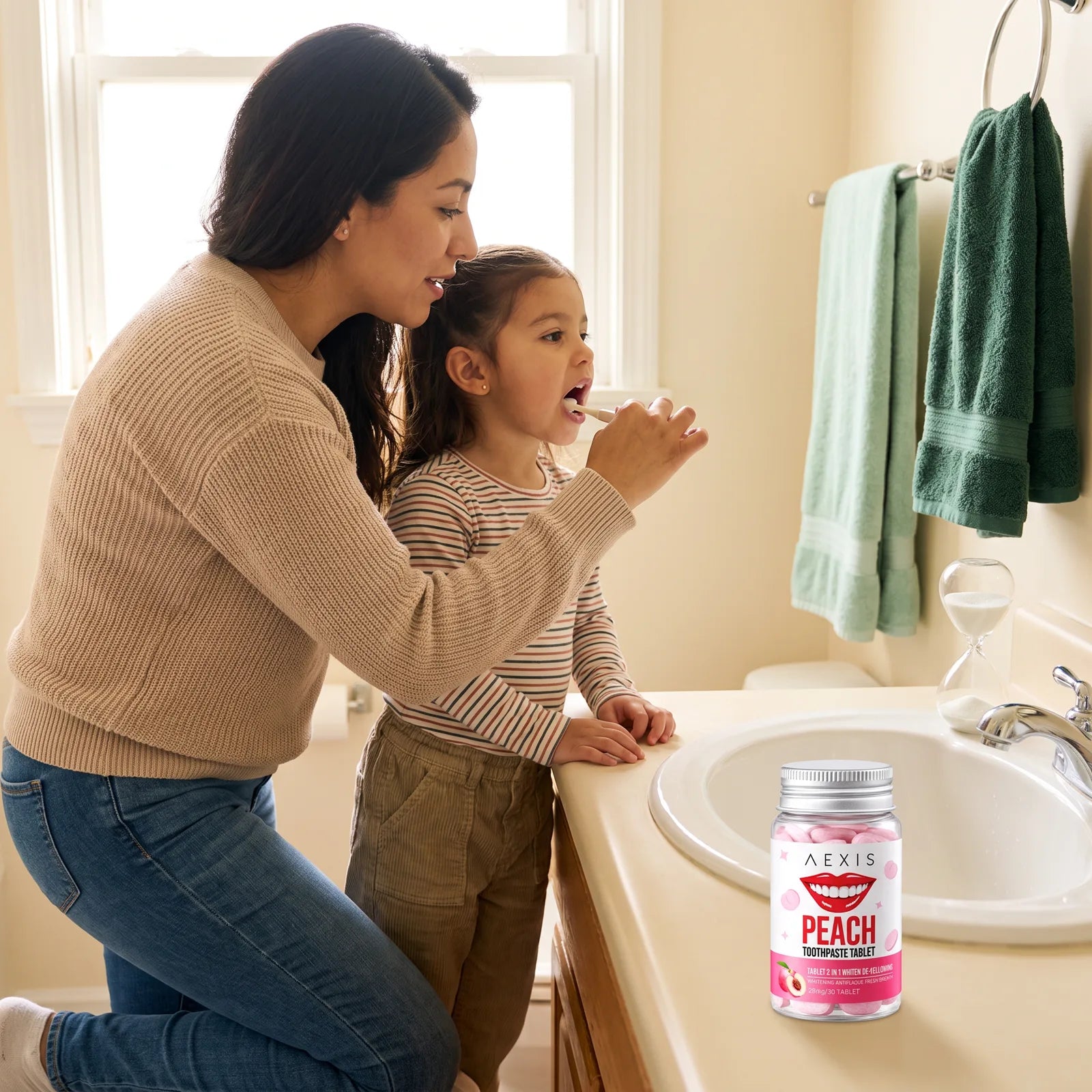 A girl brushes her teeth beside her mom, with a sand timer on the counter